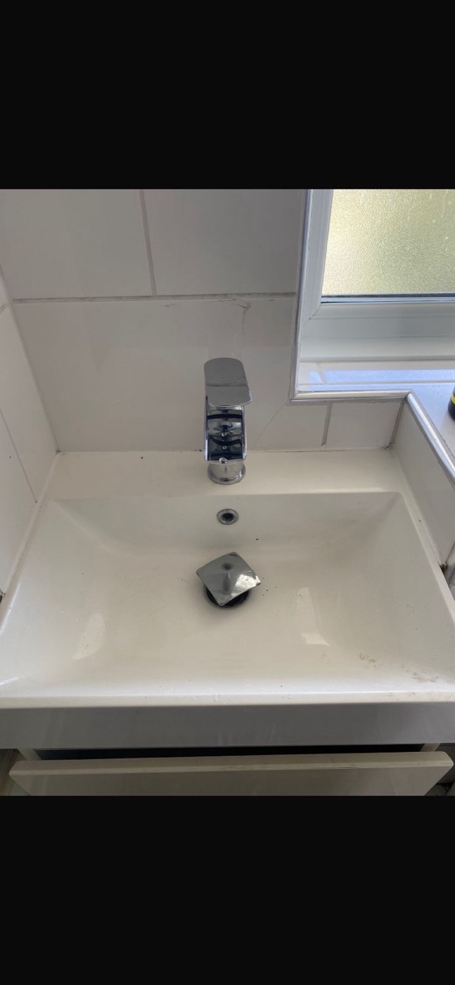 After basin tap replacement with new compact chrome mixer tap fitted to bathroom sink