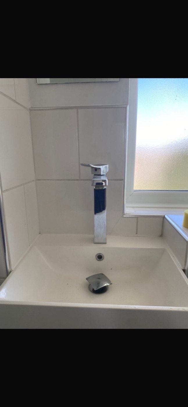 Before basin tap replacement showing older square chrome bathroom tap
