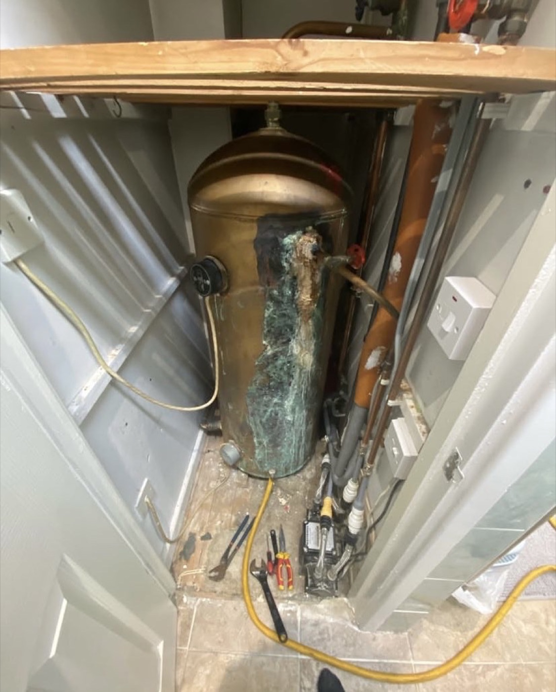 Before hot water cylinder replacement showing corroded old copper cylinder