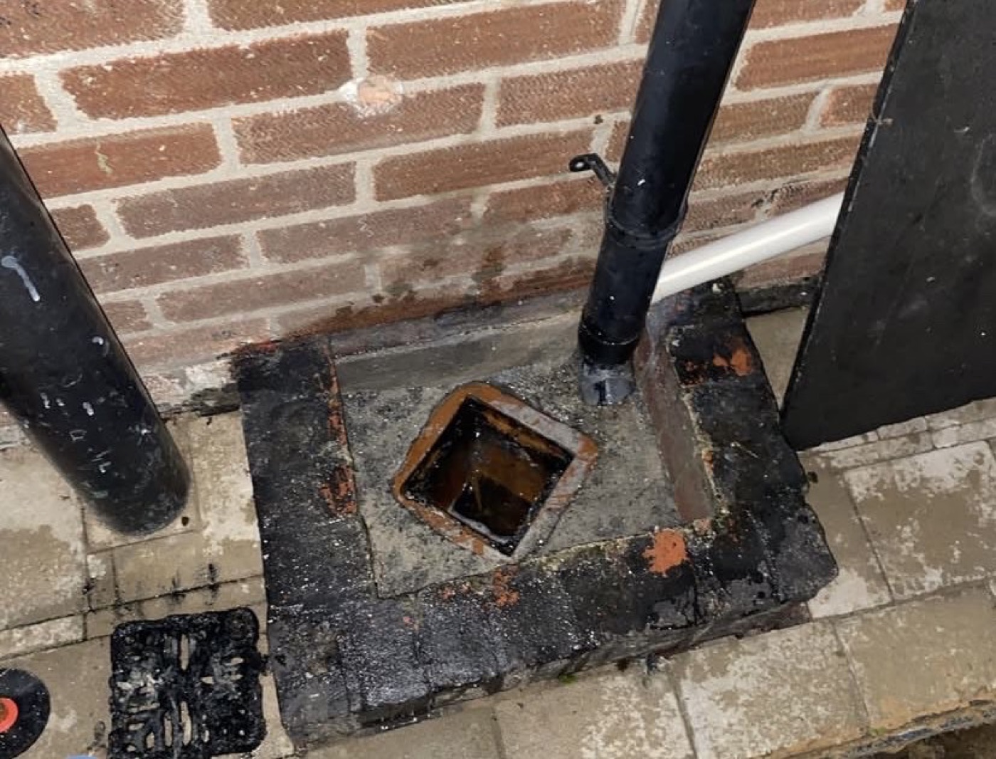 After outside drain access repair showing the drain access point opened and restored